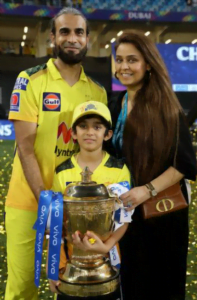 Imran tahir holding ipl trophy with his son and wife